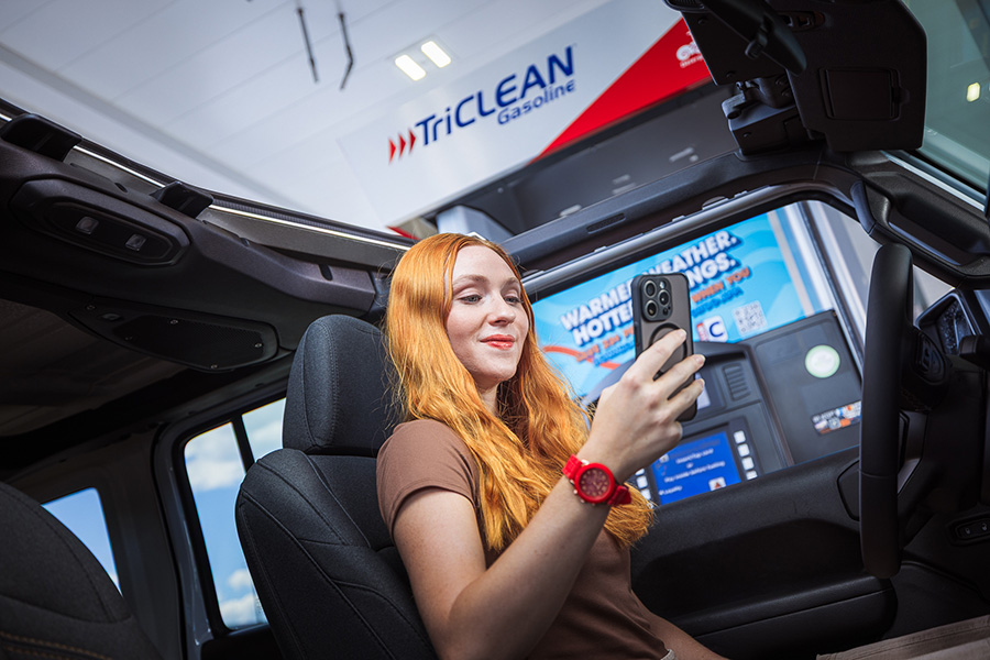 Girl holding phone with ClubCITGO app open